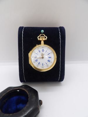 a small black box with a watch inside of it