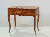 an image of a small wooden table with drawers on it