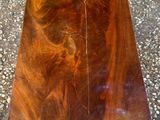 the table is made of wood and has a brown stain on it