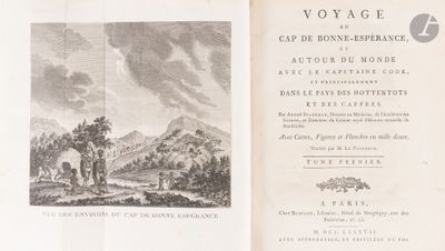 an old book with a picture of a mountain in the background
