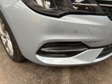 a close up of the front of a silver car
