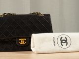 a black bag and a white towel sitting on a table