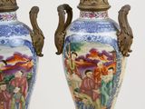 two vases with asian designs on them sitting on a table