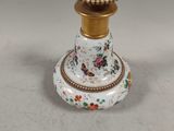 a white and gold vase with flowers on it