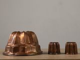 two chocolate molds sitting on a table next to each other