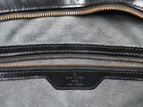a close up of a black leather bag with zippers