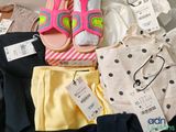 a pile of clothes and shoes on a table