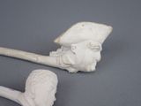 a statue of a man holding a pipe next to a pipe holder