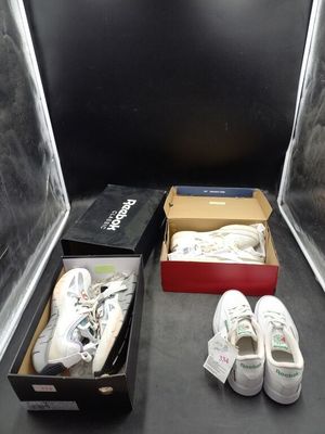 une boîte de chaussures et une paire de chaussures par terre