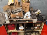 a pile of boxes and other items on a workbench