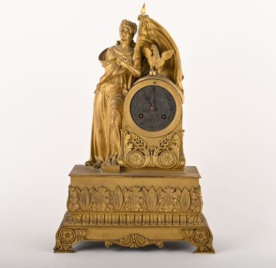 a gold clock with a statue on top of it