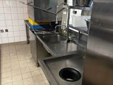a stainless steel kitchen with a sink and a stove in it