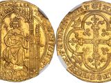 a gold coin with an image of a man holding a cross