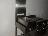 an image of a kitchen with a sink and a stove