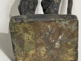 statue of a man holding a box with a dog on it