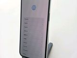 a phone that is sitting on a stand on a table