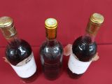 three bottles of wine that are sitting on a table