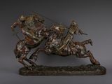 statue of a man riding a horse with a spear on his back