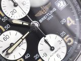 a close up of a watch with a black face