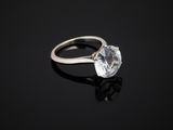 a white diamond ring on a black surface