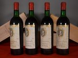 three bottles of wine sit on a table next to a wooden box