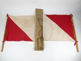 two red and white flags on a white surface with wooden poles