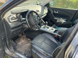 the interior of a car with the door open and the steering wheel missing