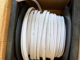 an open box with a white hose inside of it