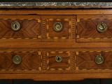 a wooden dresser with a marble top on it