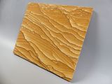 a close up of a piece of wood on a white surface