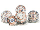 five plates and two cups and saucers on the table