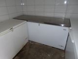 an image of a kitchen with a refrigerator and a counter
