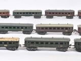 a lot of toy trains that are on a white surface