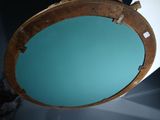 a round mirror hanging on a wall in a room