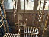 four wooden chairs sitting next to each other in a room