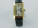 an image of a gold and black watch with roman numerals