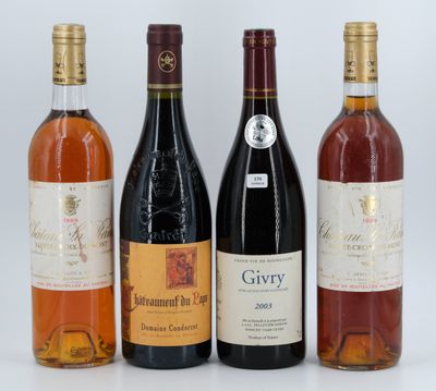 four bottles of wine are lined up on a white surface