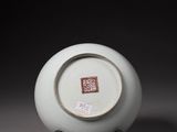 a white plate on a stand with a chinese writing on it