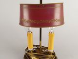 an image of a table lamp with a red shade and two yellow candles
