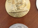 four medals on a table with a case in the background