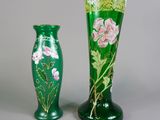 une paire de vases verts ornés de fleurs roses sur fond gris