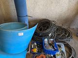 a blue bucket sitting on the ground next to a blue bucket