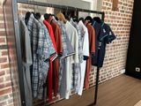 a lot of clothes hanging on a rack in a room