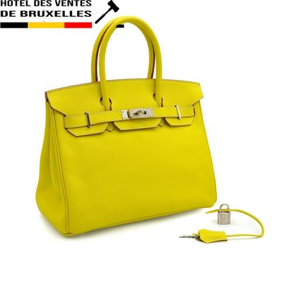 a yellow handbag with a key in the middle of it