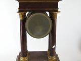 a clock that is sitting on top of a wooden stand
