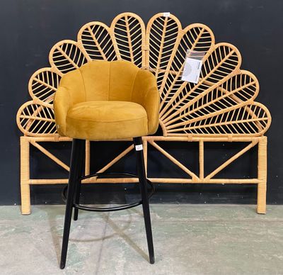 a yellow chair that is sitting on top of a stool