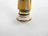 a ceramic figurine of a man with a hat and coat