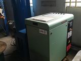 a green machine sitting in a room next to a blue machine
