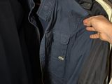 a person that is holding some clothes in a closet
