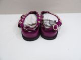 a close up of a pair of purple shoes on a white surface